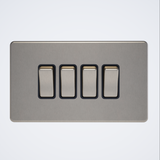 four gang screwless light switch in brushed steel with black inserts